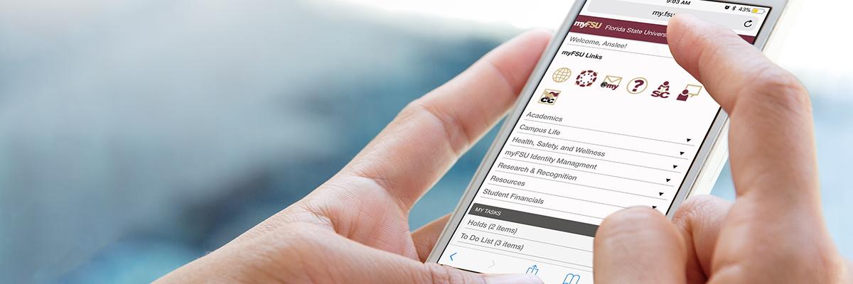 Person holding phone with myFSU Portal on screen