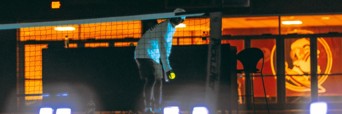 students playing glow in the dark pickleball with intramural sports