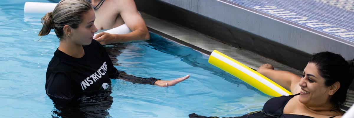 FSU Campus Recreation swim instructor holding swim lessons for an adult