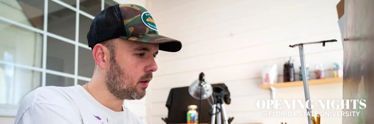 Artist Noah Verrier painting a photo