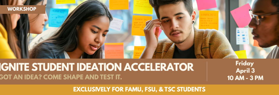 Students sitting at a table with post-it notes behind them, on a wall.