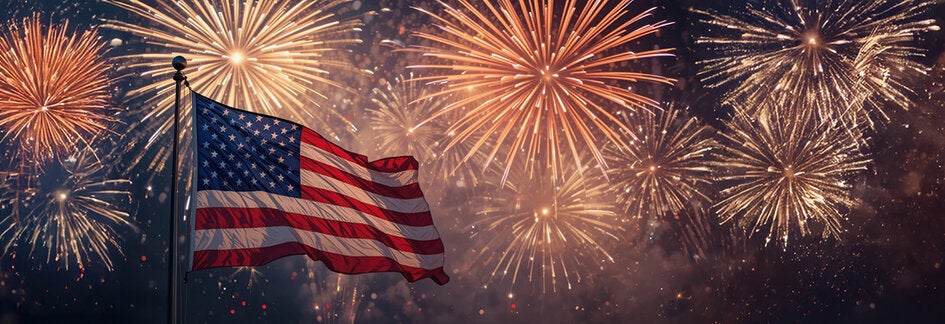 American flag with fireworks in the background.