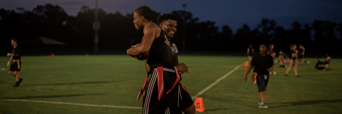 Two Students Play Flag Football