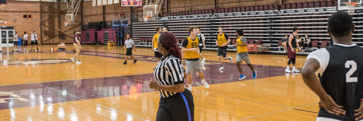 Female referee in basketball game