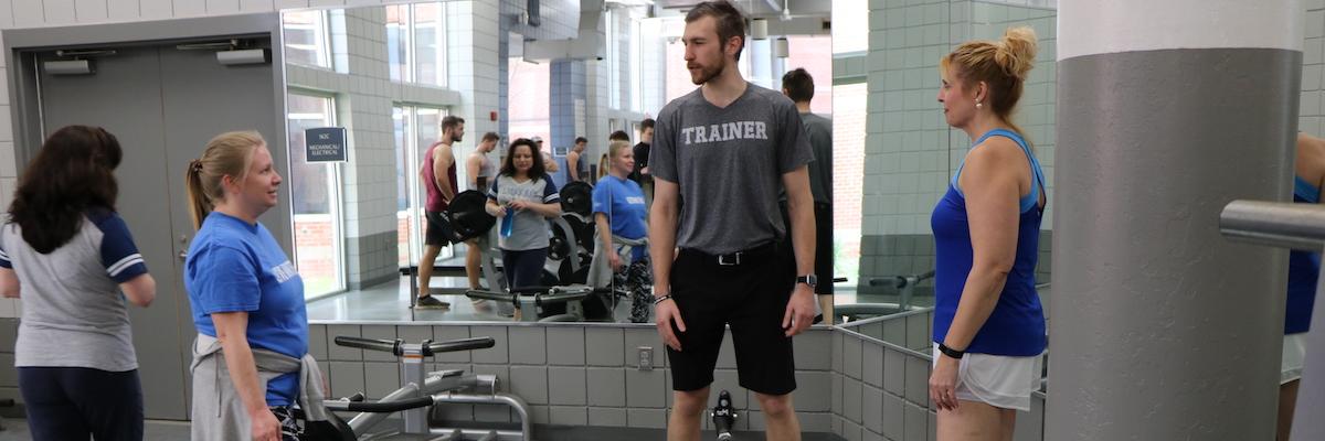 Three women and one male personal trainer