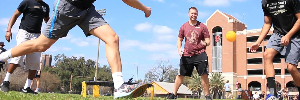 male students playing spikeball