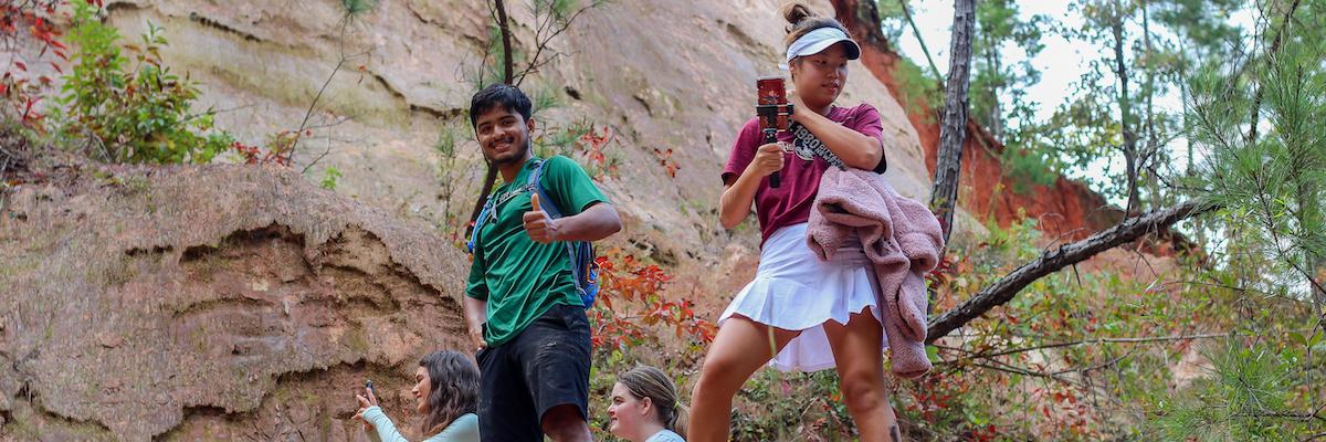 two students standing atop a cliff at Providence Canyon