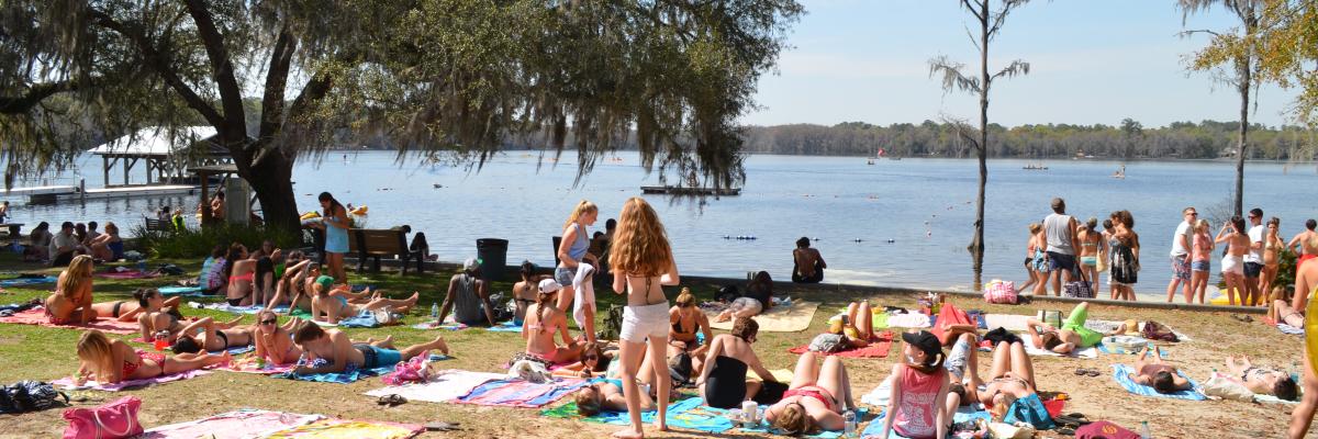 students laying out in the sun at the FSU Lakefront Park during Lake Days