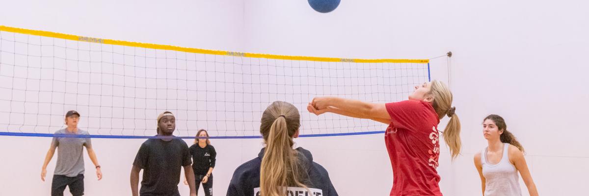 Students playing wallyball at the Leach Center